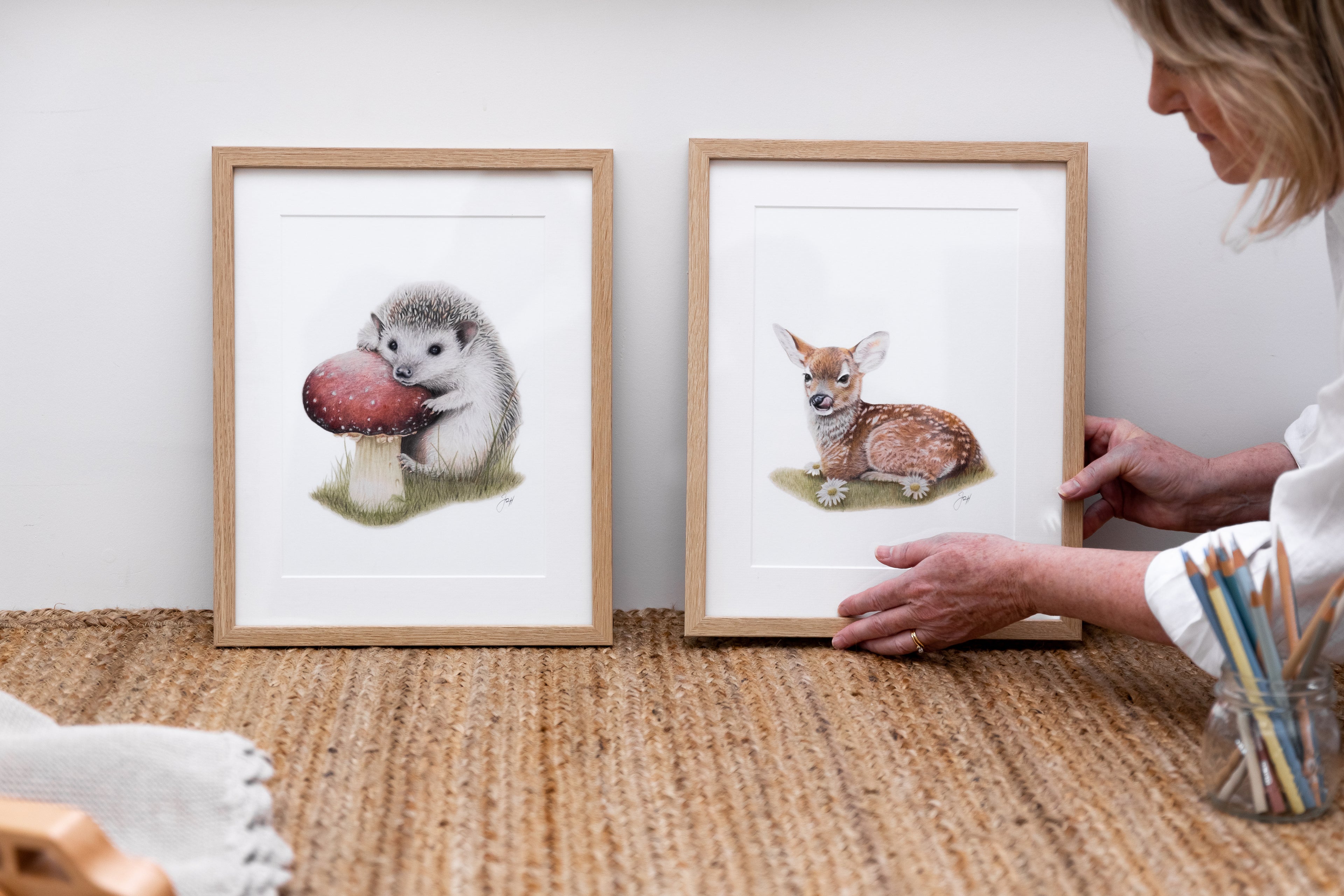 Artist Jo arranging a framed print of the Woodland Fawn for display