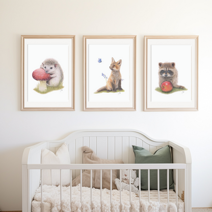 Framed prints of the Woodland Hedgehog, Fox and Raccoon on a nursery wall